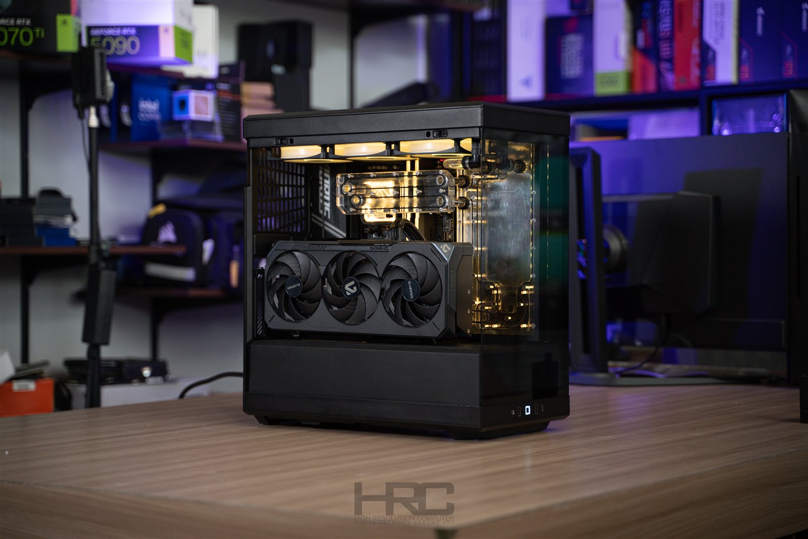 HYTE Y40 / BLACK. Warm lighting and a dark enclosure put the hardware and clean tubing in focus.